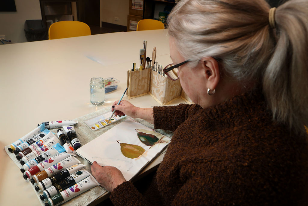 Resident painting a masterpiece during a creative art session.