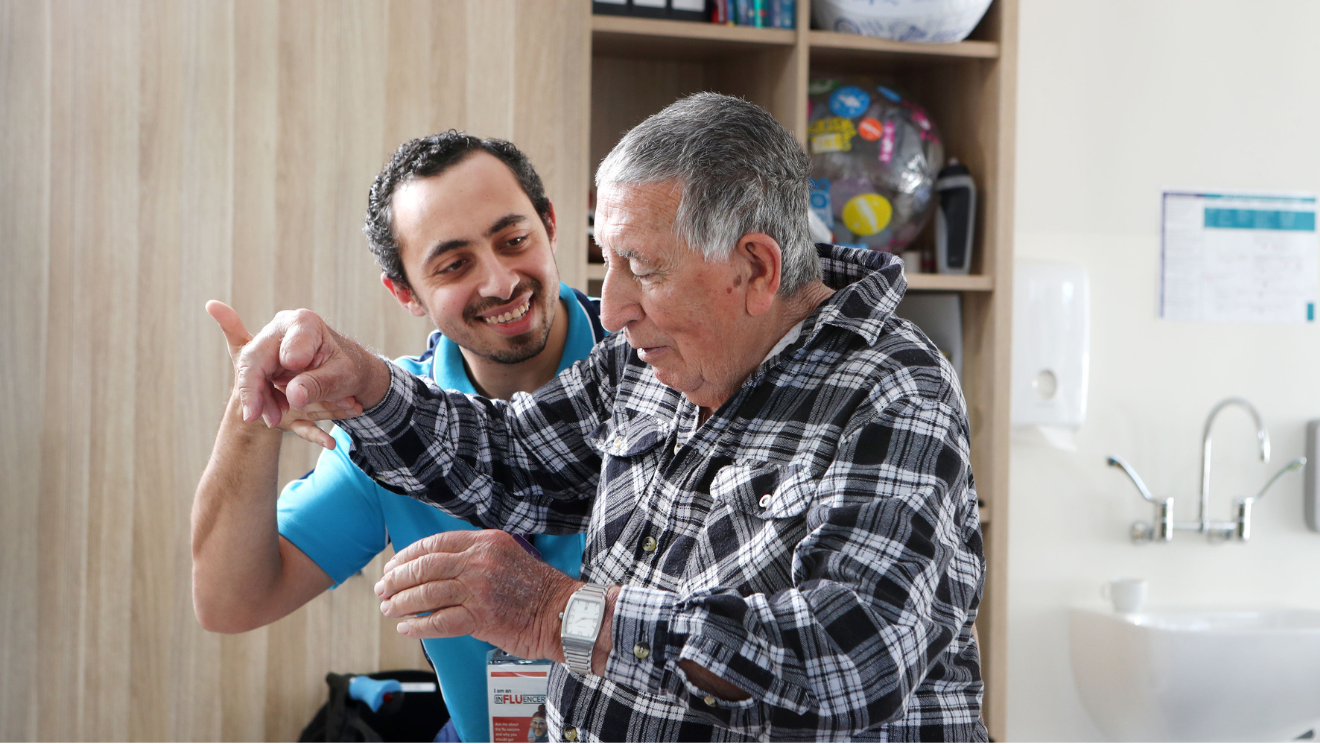 Warrigal aged care staff member smiles at resident while completing physio exercises