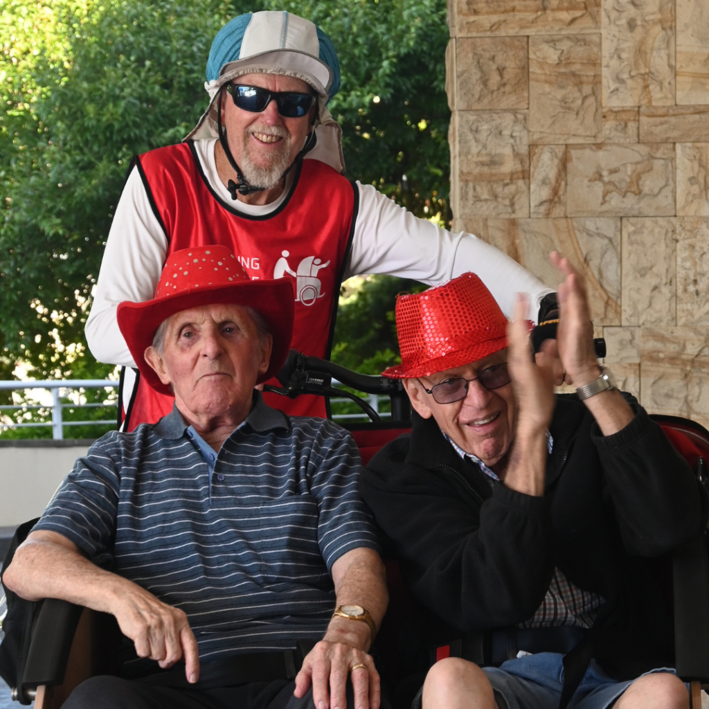 Smiling residents on board trishaw bike at Warrigal Wollongong