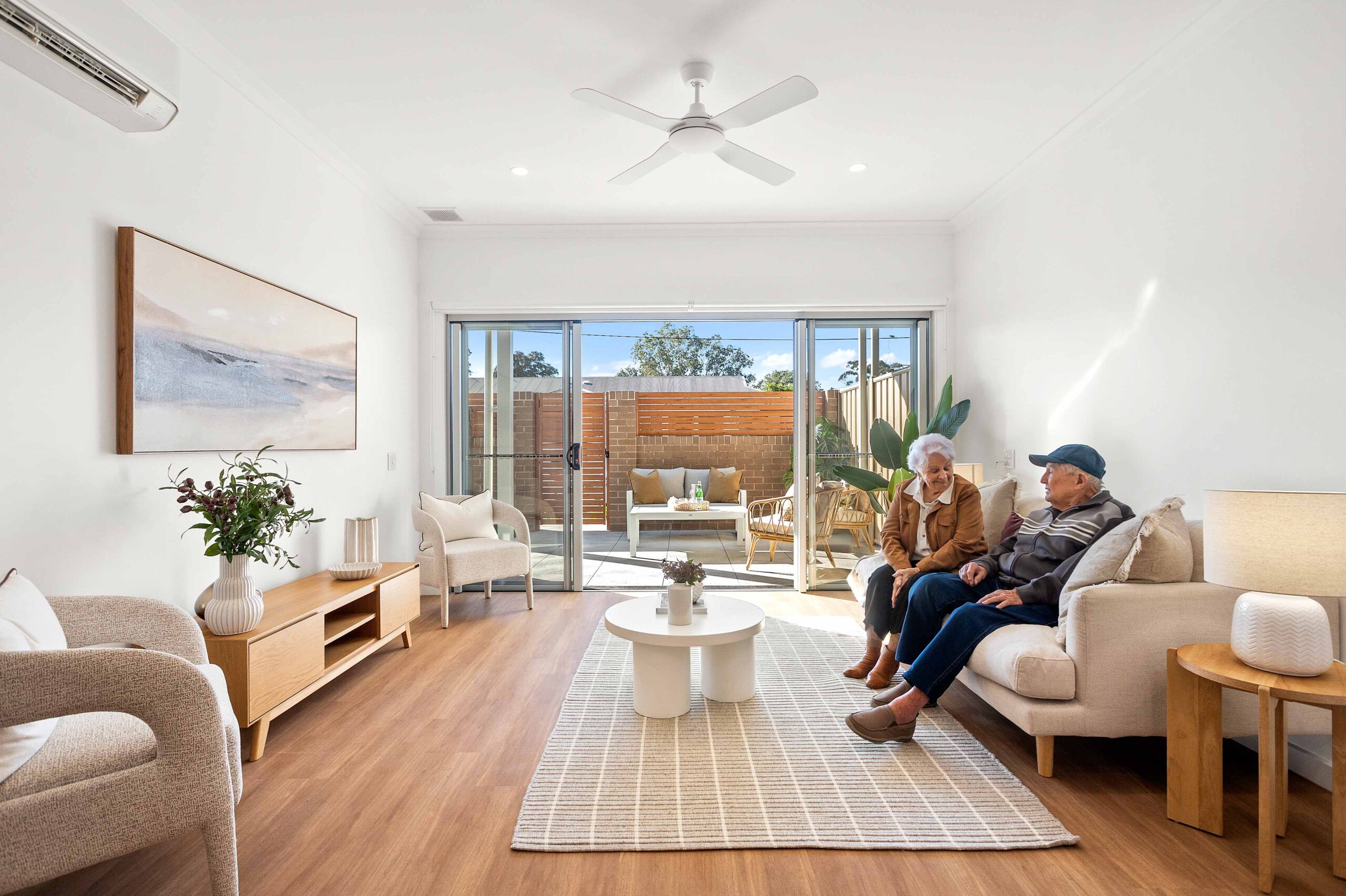 Warrigal Lake South man and woman sit in villa