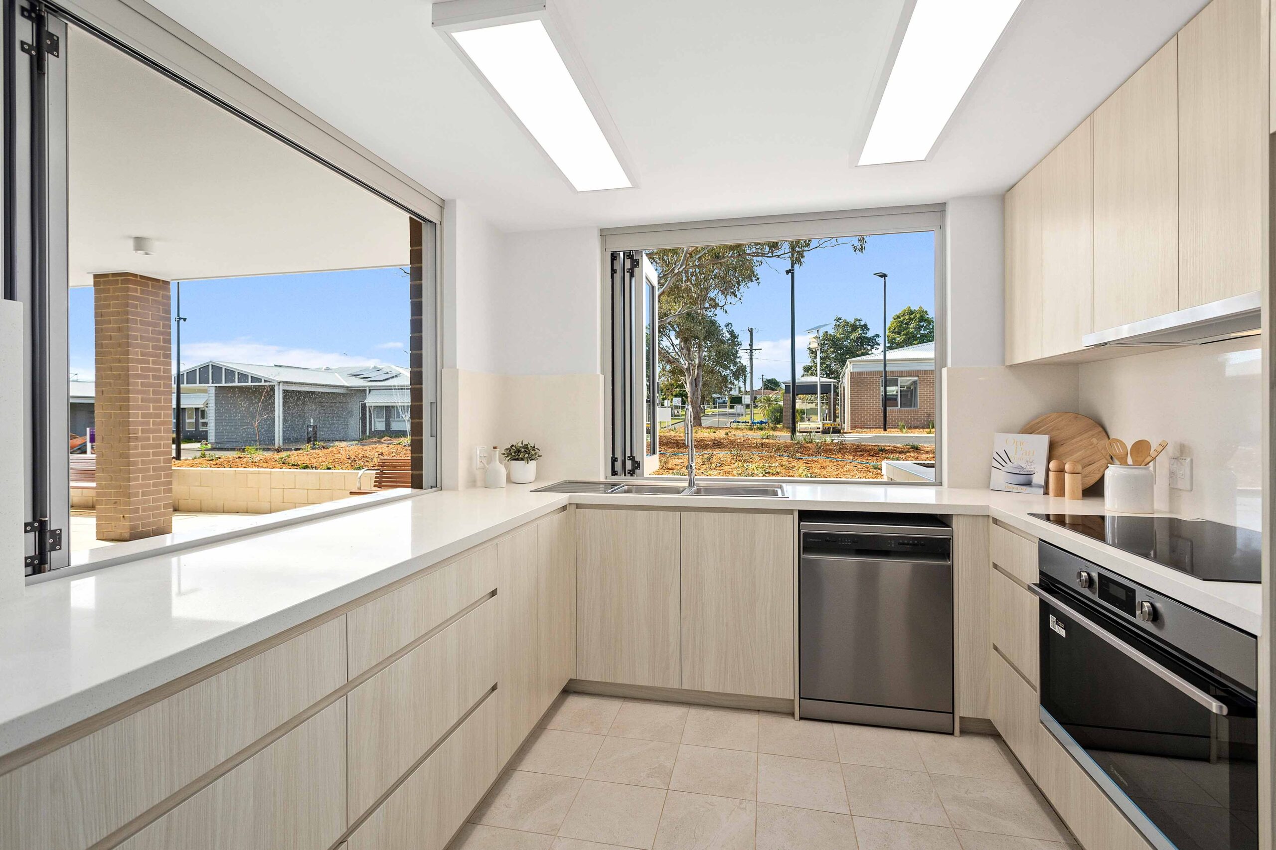 Community hub kitchen at Warrigal Lake South shown with outdoor area visible