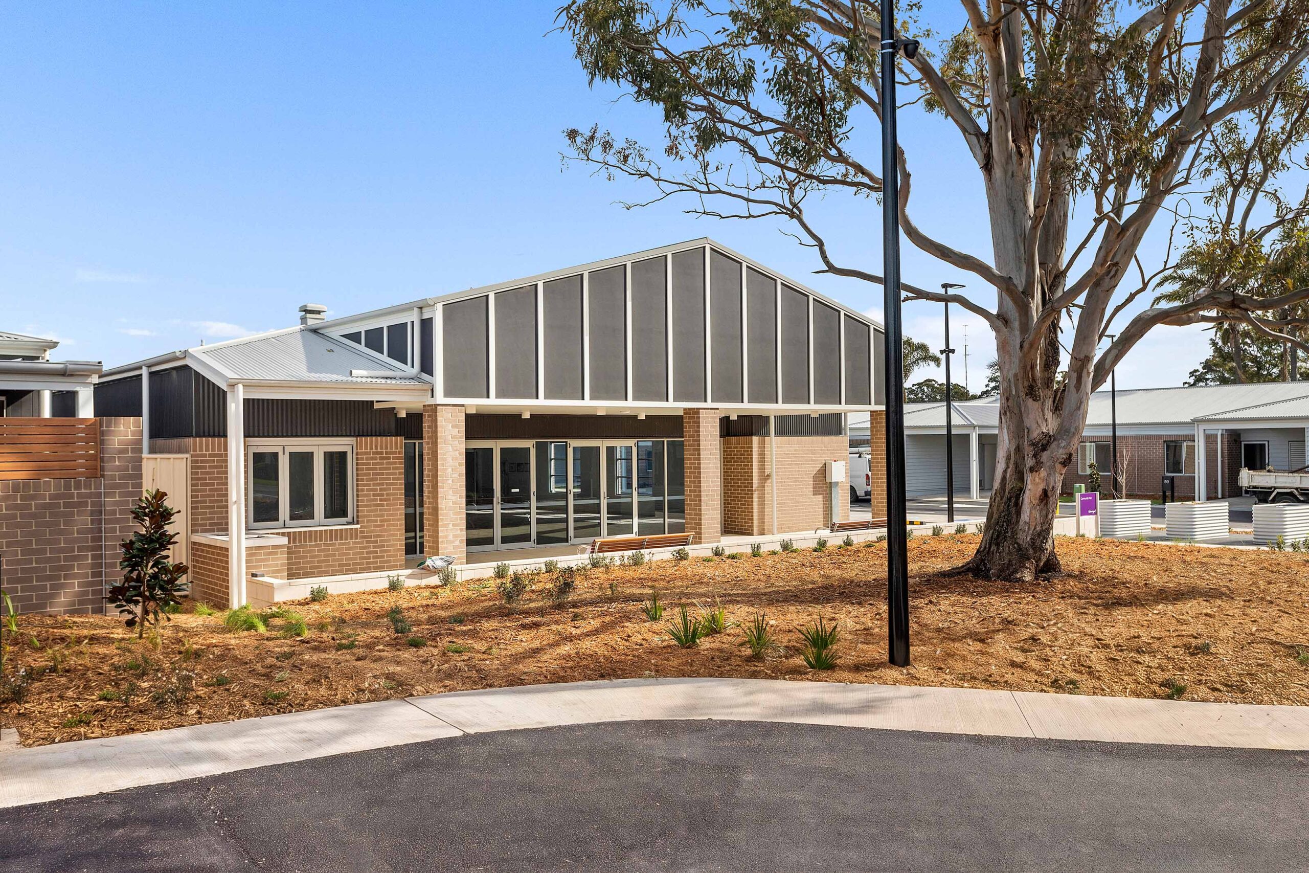 Exterior of Warrigal Lake South community hub shown with garden