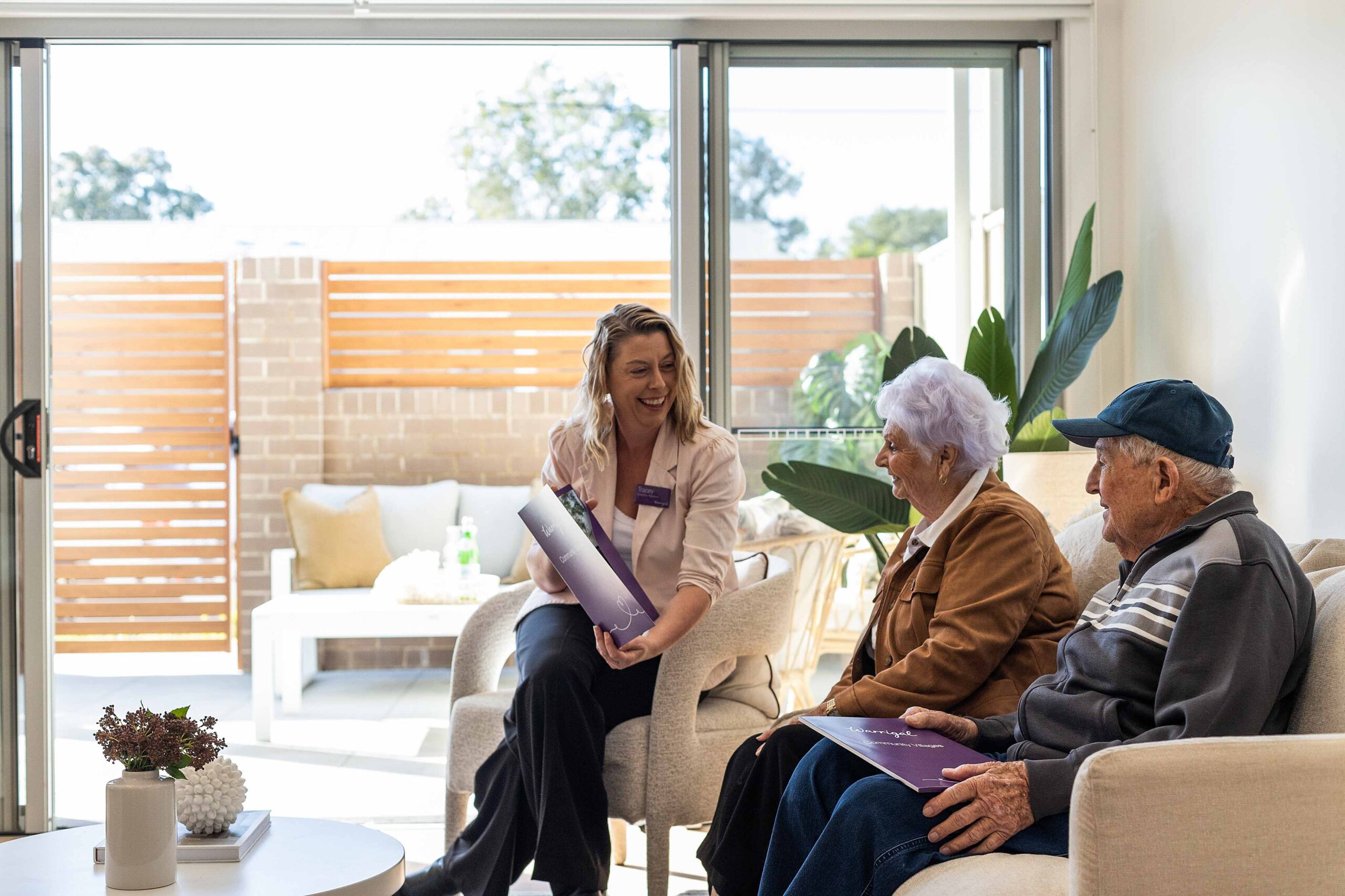 Man and woman speak to Warrigal sales team member