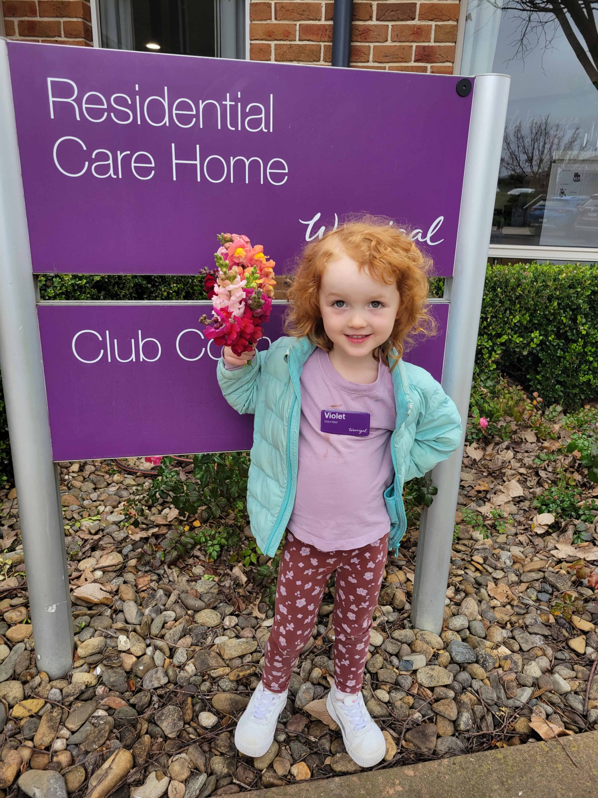Young Volunteer at Warrigal sign